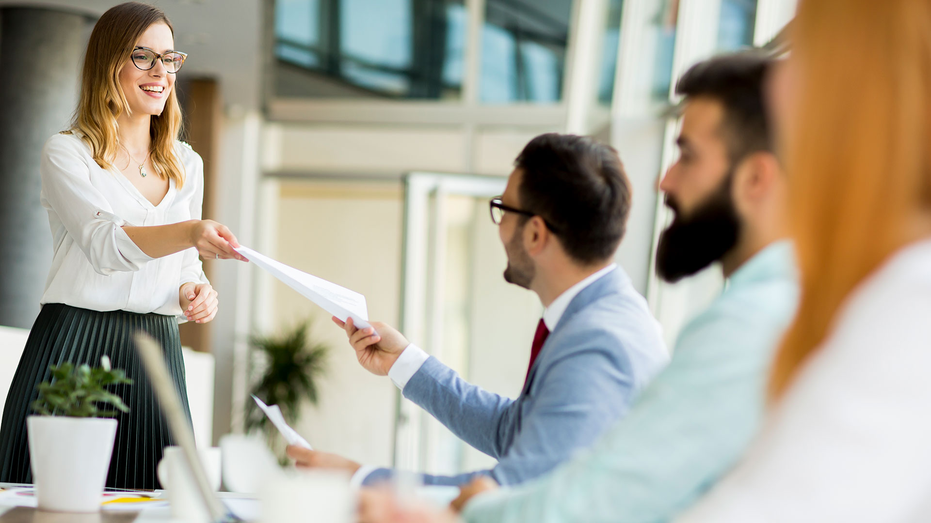 Business Team handing over paper